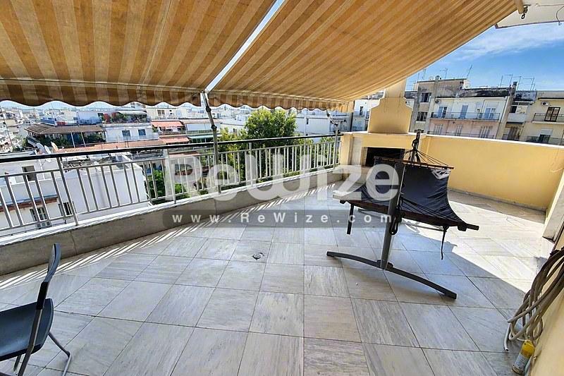Σύγχρονη όψη μονοκατοικίας με χρυσαφί πέτρινη επένδυση και κήπο στη Χαλκιδική.