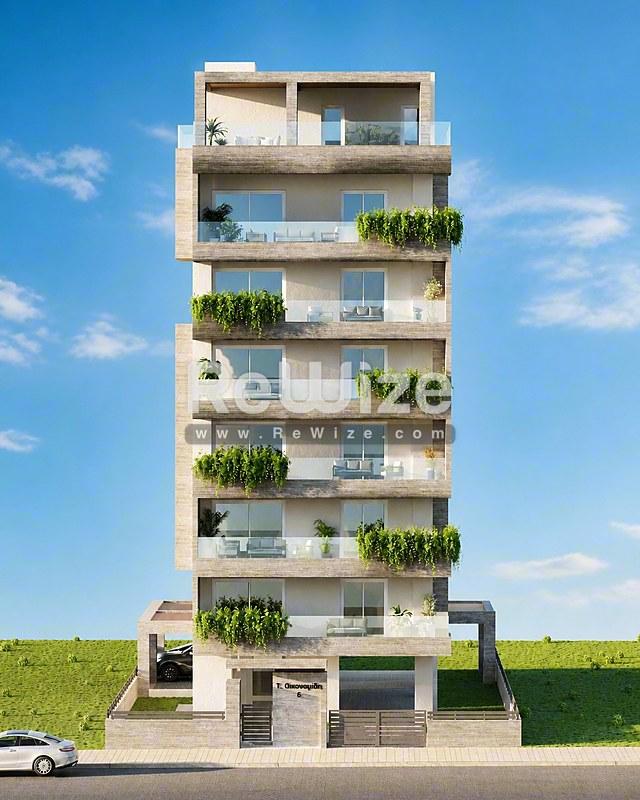 Σύγχρονη πολυκατοικία στη Χαλκιδική με πράσινα μπαλκόνια και σύγχρονη αρχιτεκτονική.